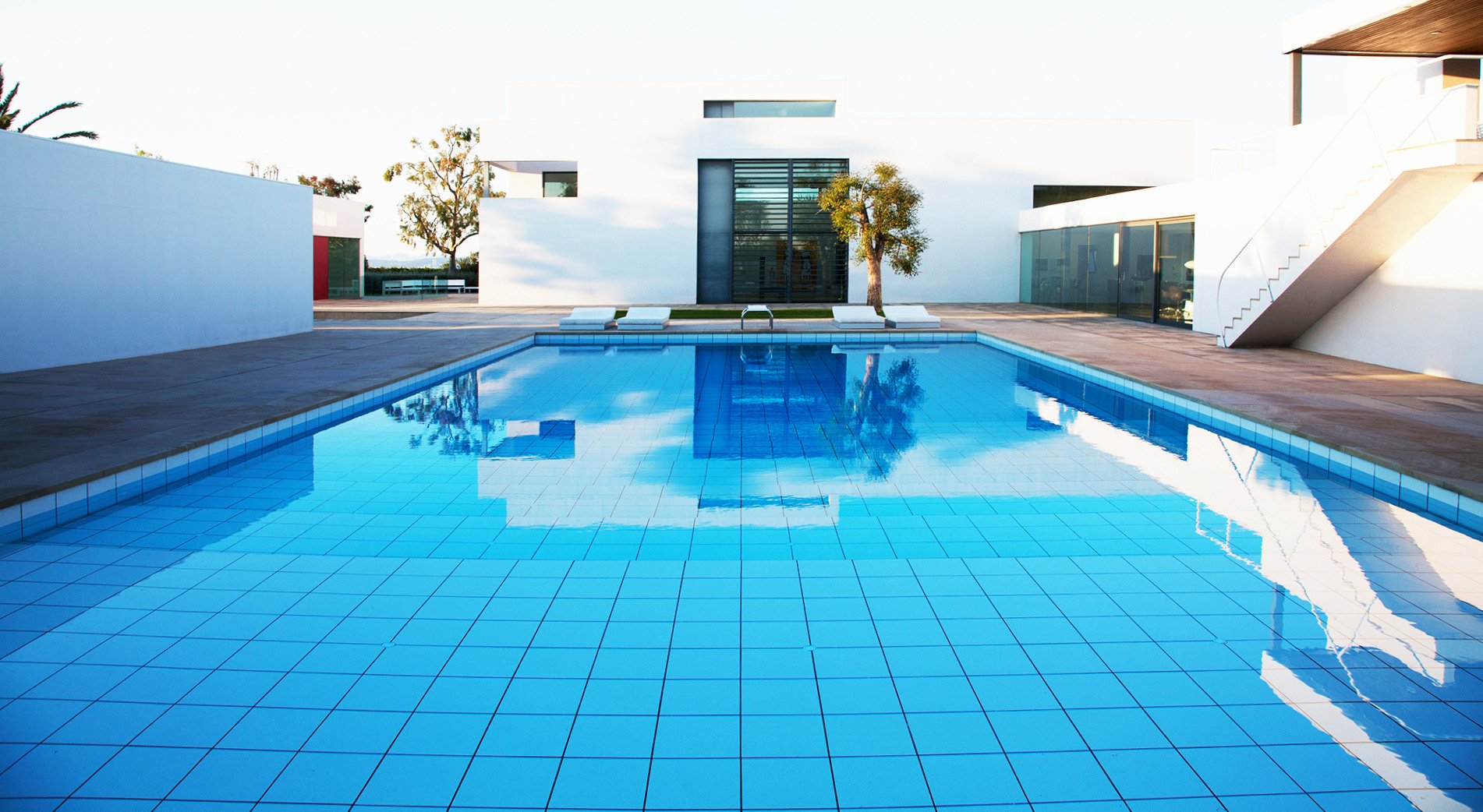 Sunlit swimming pool with clear blue water